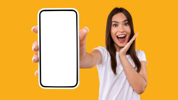 istock Excited woman showing white empty smartphone screen 1342234919