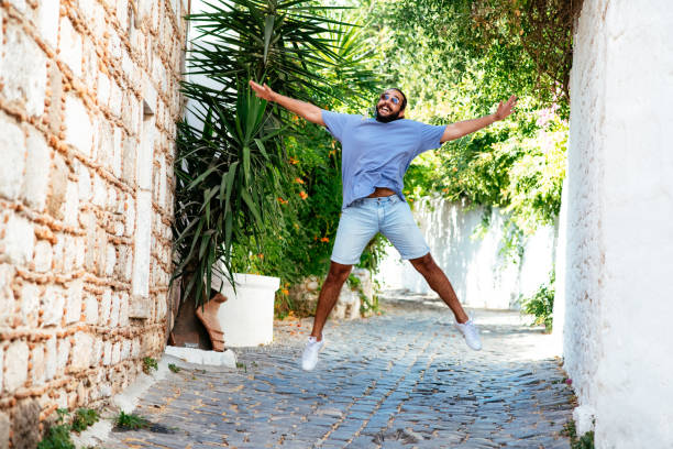 istock Cute Young Man Jumping For Joy 1342235024