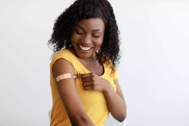 istock Covid-19 Vaccinated African Female Looking At Arm With Plaster, Studio 1342235628