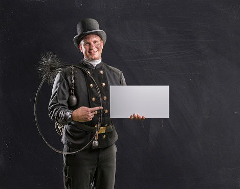 Chimney sweeper in uniform holding empty card