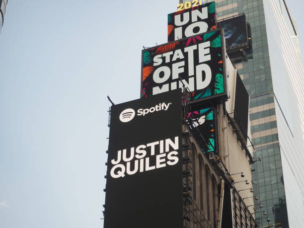 Spotify Billboard in Times Square New York City, New York United States - August 29 2021: Spotify Justin Quiles black billboard advertisement in Times Square with logo. album title stock pictures, royalty-free photos & images