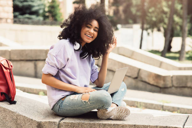 istock Bushy Black Female Student Using Laptop Computer Sitting Outdoors 1342238213