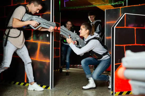 Photo of Young people having fun on lasertag arena