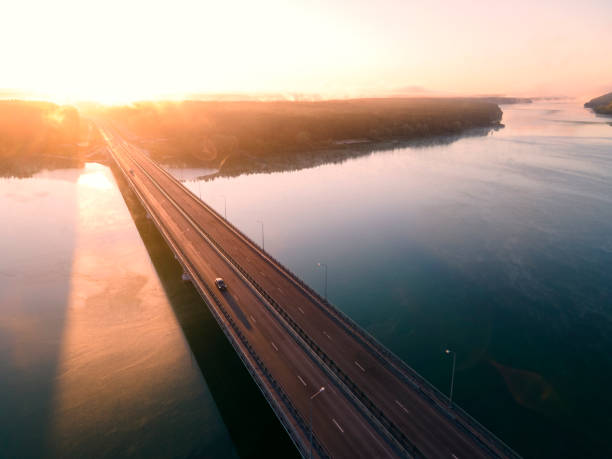 istock Beautiful sunset road Highway with river Bridge, Aerial View 1342239509