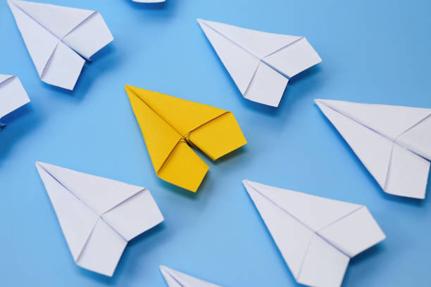 istock yellow paper plane is leadership with white paper plane 1342239553