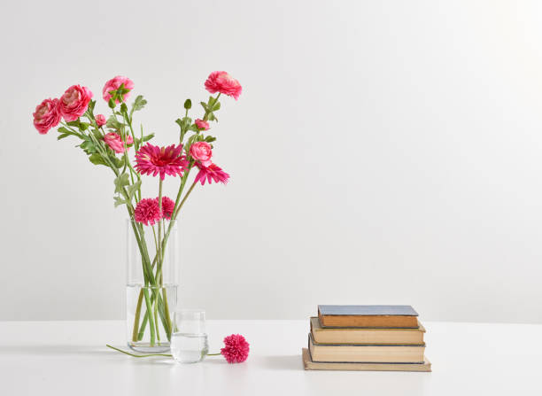 istock white background and flower vase book wood table 1342239834