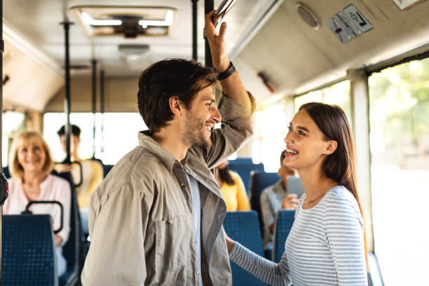 istock Beautiful smiling couple standing in bus and talking 1342240000