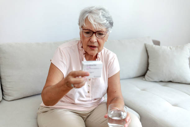 istock Senior woman looking at prescription box. 1342241103
