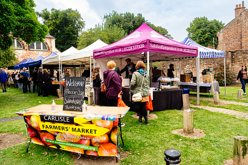 Carlisle, United Kingdom: September 04, 2021: Farmer's market on the green at the south east corner of Carlisle Cathedral in the city of Carlisle in the north of England.