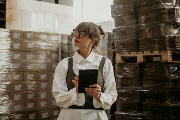 istock Female professional assistant checking stock in factory 1342241467
