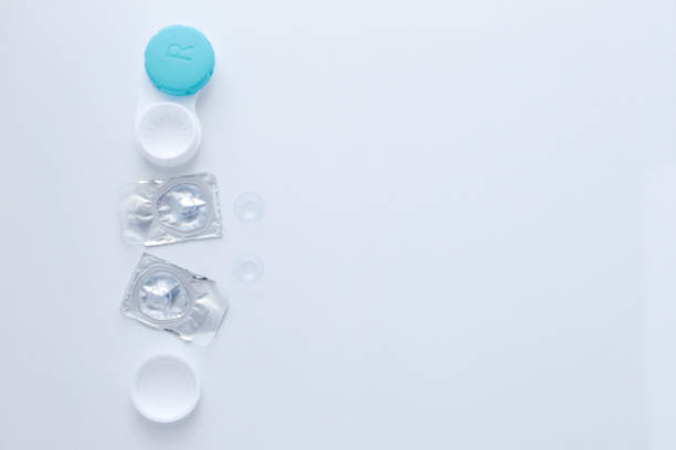 istock A container for lenses, two sealed lenses and lenses lying t lay 1342241539