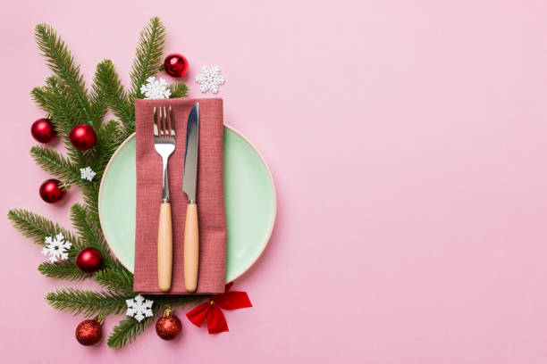 istock Christmas table place setting with christmas decor and plates, kine, fork and spoon. Christmas holiday background. Top view with copy space 1342242609