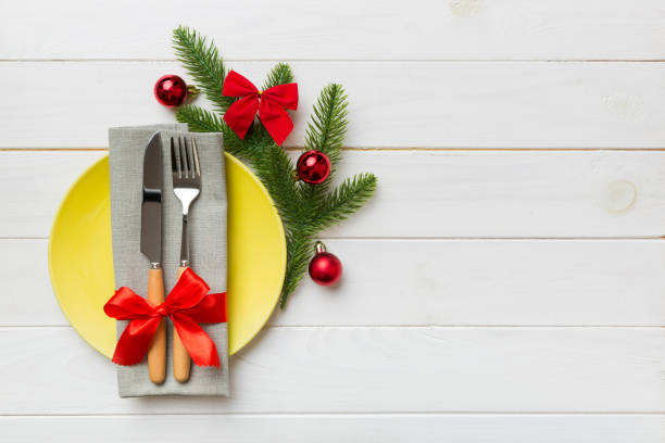 istock Christmas table place setting with christmas decor and plates, kine, fork and spoon. Christmas holiday background. Top view with copy space 1342242612
