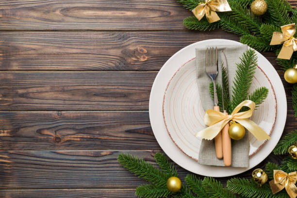istock Christmas table place setting with christmas decor and plates, kine, fork and spoon. Christmas holiday background. Top view with copy space 1342242619