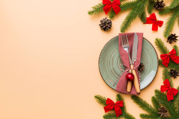 istock Christmas table place setting with christmas decor and plates, kine, fork and spoon. Christmas holiday background. Top view with copy space 1342242623