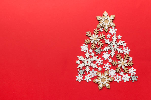 istock Christmas tree made from colored handmade ball decoration on colored background, view from above. New Year minimal concept with copy space 1342242638