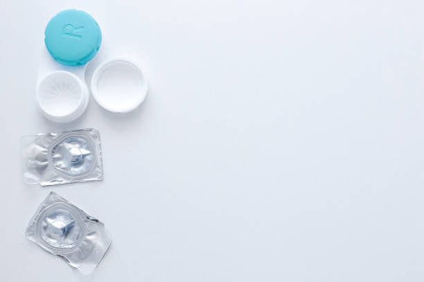 istock A container for lenses and two sealed lenses lie on the side on a white background with space for text. top view, flat lay, copy space, isolate 1342242944