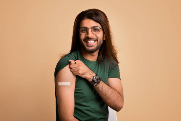 istock Handsome indian man got vaccinated, showing shoulder with plaster 1342243706