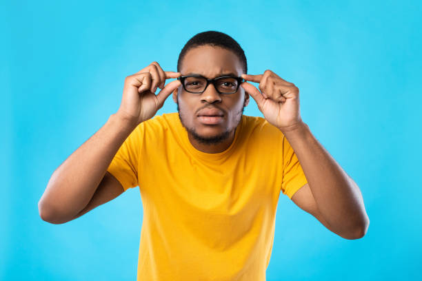 istock Black Guy In Glasses Squinting Eyes Posing Over Blue Background 1342243749