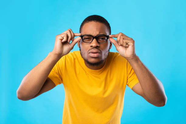 istock African American Guy With Poor Eyesight Squinting Eyes, Blue Background 1342243982
