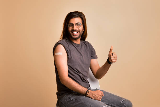 istock Cheerful indian guy showing thumb up, got vaccinated against COVID-19 1342244191