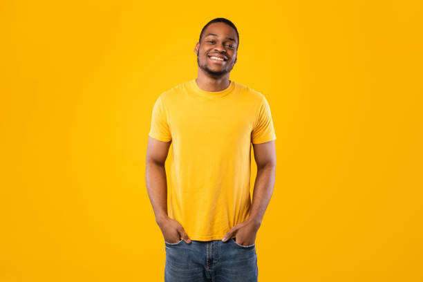 istock African American Man Posing Holding Hands In Pockets, Yellow Background 1342245141