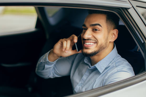 istock Cheerful middle-eastern manager talking on cellphone, sitting in car 1342245269