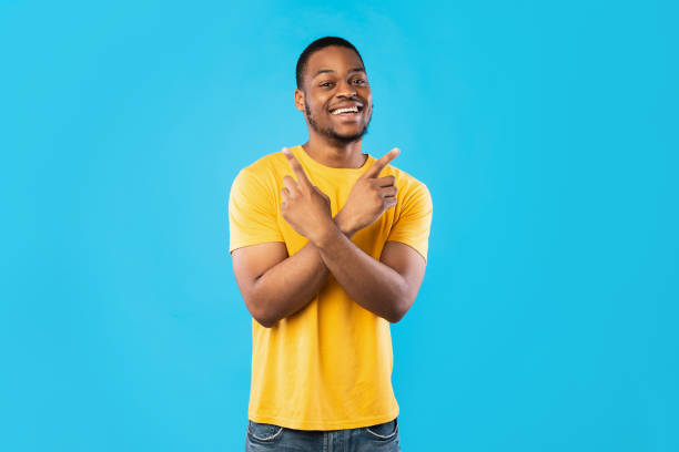 istock African American Guy Pointing Fingers Crossing Hands Over Blue Background 1342245609