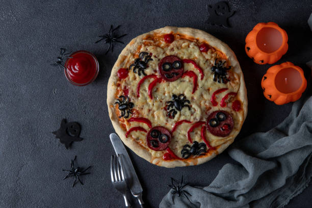 istock Halloween funny pizza with spiders, Creative idea for Halloween pizza on dark gray background, View from above 1342246757