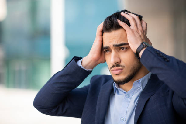 istock Stressful middle-eastern businessman touching his head, business failure 1342246901