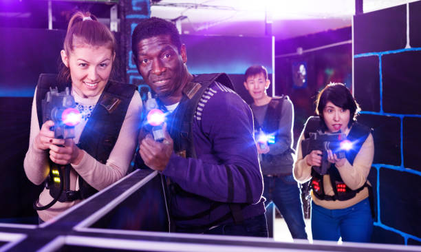 istock Young man and woman playing laser tag 1342247256