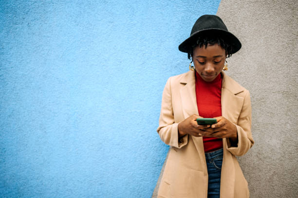 istock Young casually clothed woman posing in front of coloured wall 1342248216