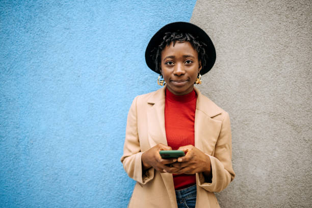 istock Young casually clothed woman posing in front of coloured wall 1342248254
