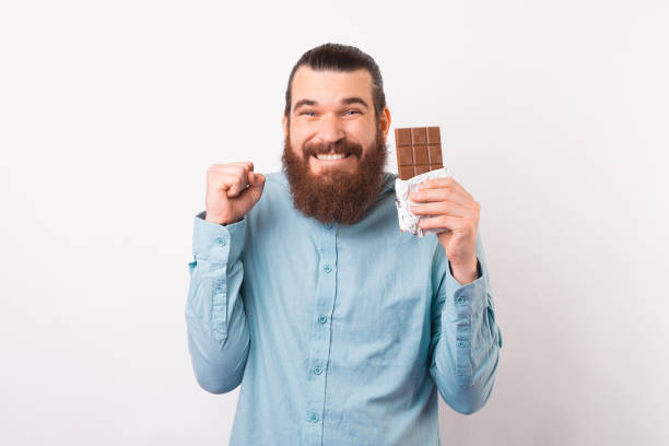 istock Bearded man is excited about a chocolate break while holding one. 1342248393