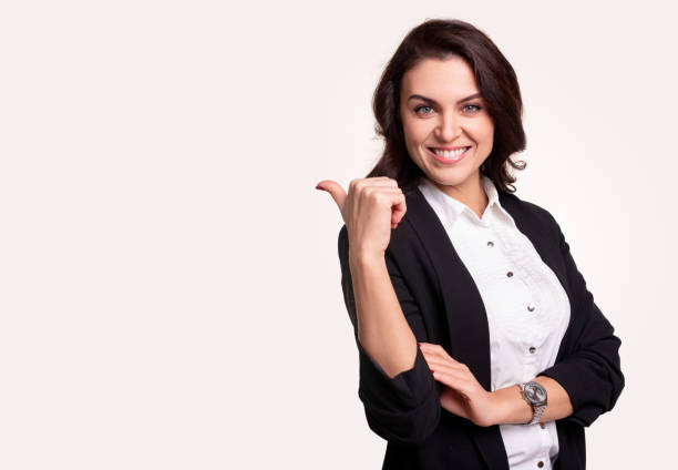 istock Cheerful businesswoman pointing at blank space 1342248444