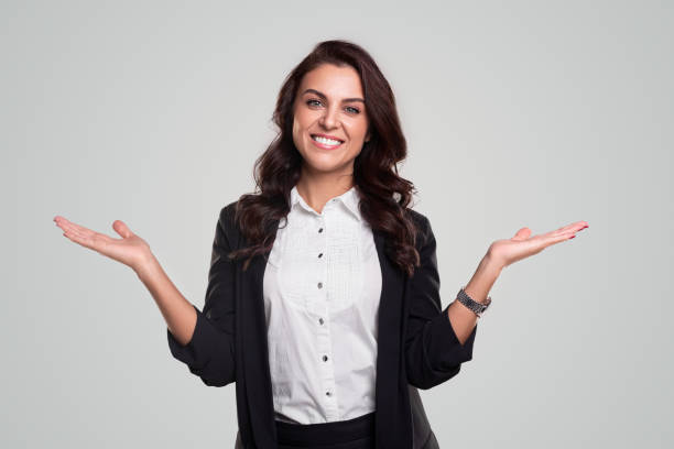 istock Cheerful businesswoman pointing aside and looking at camera 1342248459