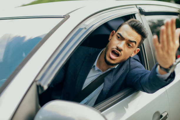 istock Furious middle-eastern businessman driving car, fighting on road 1342252146