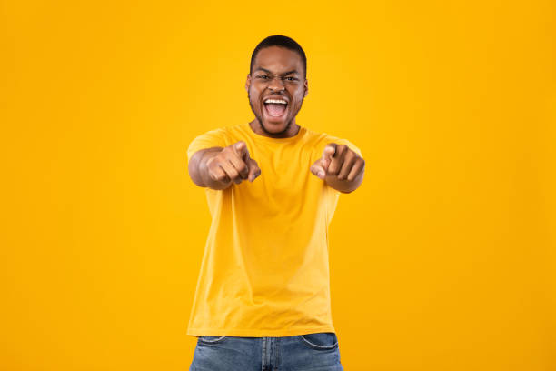 istock African Man Pointing Fingers With Both Hands At Camera, Studio 1342252517