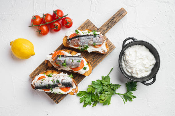 istock Ricotta sardine toast, on white stone table background, top view flat lay 1342253413