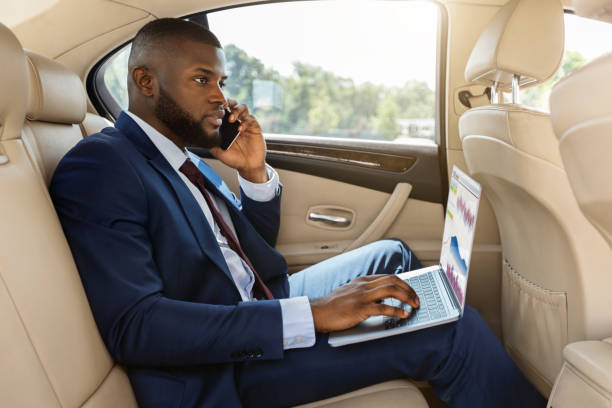istock Rich afro american businessman working in car 1342253785