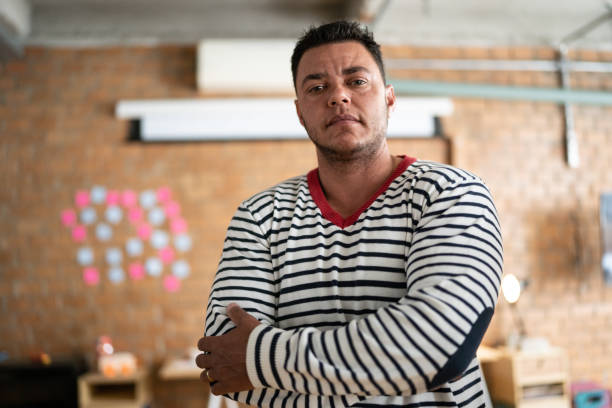 Portrait of a transgender mature man at work Portrait of a transgender mature man at work queer man facing camera stock pictures, royalty-free photos & images