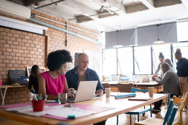 istock Colleagues working together at a coworking 1342254067