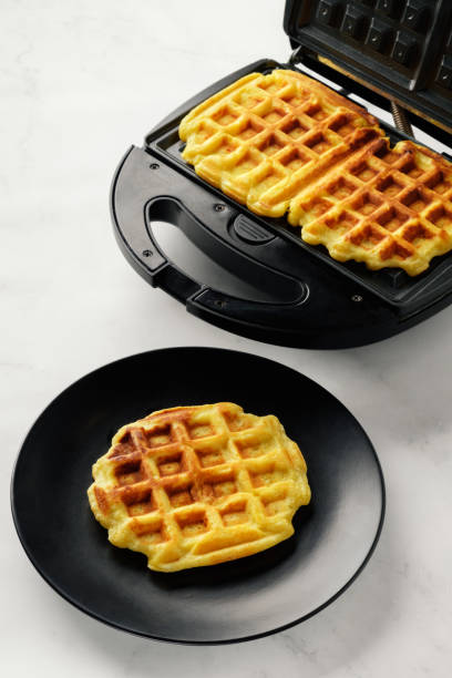 istock Cooking homemade savory or sweet waffles with waffle maker.  Selective focus. 1342254077
