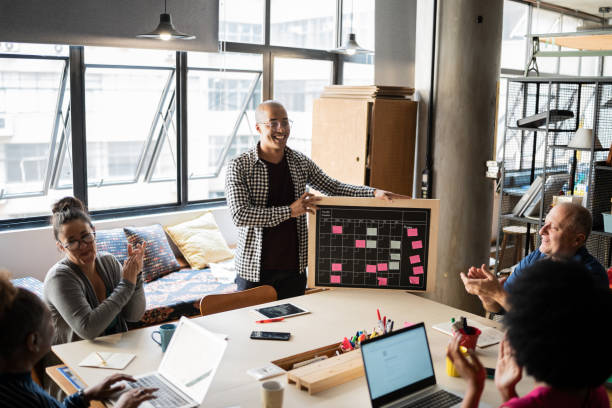 istock Young man talking and colleagues applauding in a meeting at work 1342254547