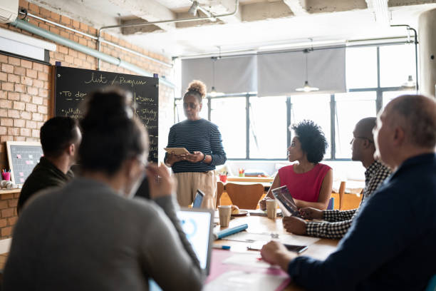istock Senior woman talking in a meeting at work 1342254574