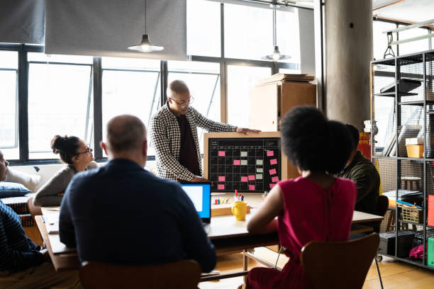 istock Young man talking in a meeting at a coworking 1342254580