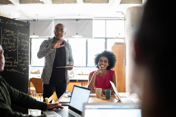 istock Young man talking in a meeting at a coworking 1342254681