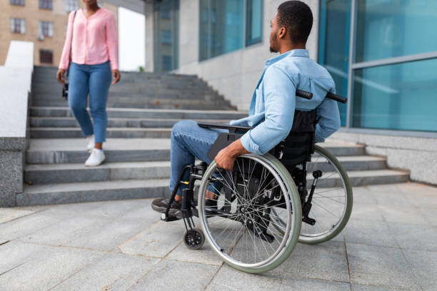 istock Black disabled guy suffering from lack of wheelchair friendly facilities, cannot enter building without ramp 1342254755