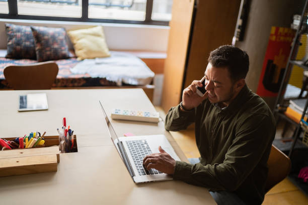 istock Transgender man talking on the smartphone and using the laptop 1342255429