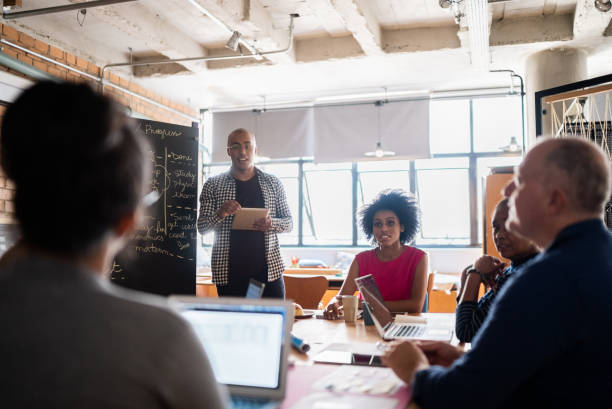 istock Young man talking in a meeting with team at work 1342255503